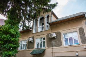 a large house with windows and an attic at George&Marry Guest House and hostels in Chişinău