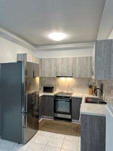 a kitchen with a stainless steel refrigerator and cabinets at The lighthouse in Chalkida
