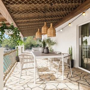 una mesa blanca y sillas en un patio en Robinsone House La Storia en Jelsa