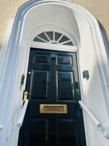 a black door with a white arch above it at 6 Wye Valley Chambers, Ross-on-Wye in Ross on Wye