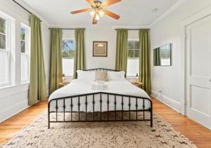 a bedroom with a bed with a ceiling fan at Luxury Duplex 4 BR House In Jacksonville in Jacksonville
