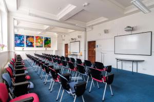 a lecture room with chairs and a white wall at Westminster College in Cambridge