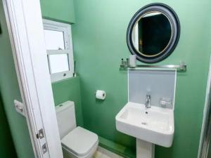 a bathroom with a sink and a mirror and a toilet at Pass the Keys Traditional room Tavmar Apartments in Lincoln