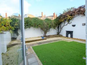 a view of a garden from the window of a house at Pass the Keys Traditional room Tavmar Apartments in Lincoln