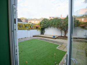 a view of a yard from a window at Pass the Keys Traditional room Tavmar Apartments in Lincoln