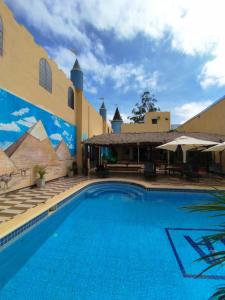 a large swimming pool in front of a building at Hotel Villa in San Juan del Paraná