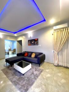 a living room with a couch and a table at Spacious two bedroom@City center in Kadobunkuro