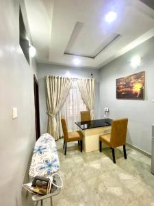 a living room with a table and chairs at Spacious two bedroom@City center in Kadobunkuro