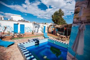 a swimming pool in front of a building with a mural at Greek Camp in Dahab
