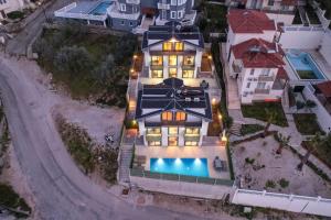 an aerial view of a house with a swimming pool at Villa Simge 4+1 Ölüdeniz in Fethiye