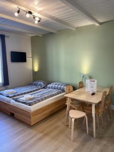 a bedroom with a bed and a wooden table at Interlaken Apartments in Interlaken