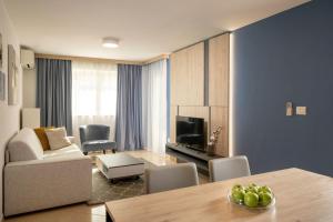 a living room with a couch and a dining room table at Apartment Garden Palace B228 in Umag