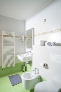 a white bathroom with a sink and a toilet at Apartment Garden Palace B228 in Umag