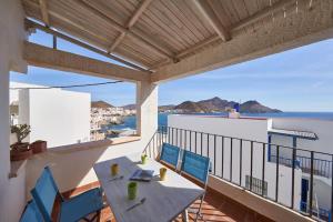 a balcony with a table and chairs and the ocean at Rhea in San José