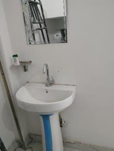 a bathroom with a white sink and a mirror at Ram Tilak homestay in Faizābād