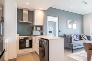 a kitchen and living room with a washer and dryer at Oceans Umhlanga Accommodation in Durban