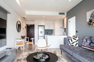 a living room with a couch and a table at Oceans Umhlanga Accommodation in Durban