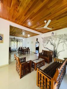 a room with chairs and tables and a mural on the wall at Rathna Villas in Bentota