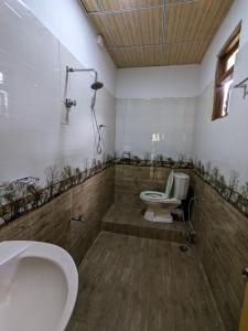 y baño con aseo y lavamanos. en DILSHAN HOTEL Diyaluma, en Koslanda