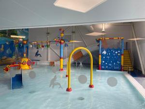 a indoor swimming pool with a water park at Luxurious Beach Resort & Golf Club in Hunstanton