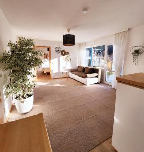a living room with a couch and a table at Ferienwohnung Herzlicht in Titisee-Neustadt