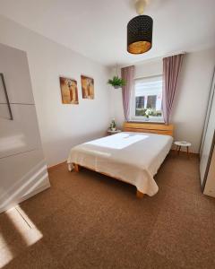 a bedroom with a large bed and a window at Ferienwohnung Herzlicht in Titisee-Neustadt