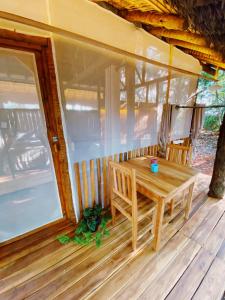 a wooden table on the porch of a house at EcoAraguaia Jungle Lodge in Caseara