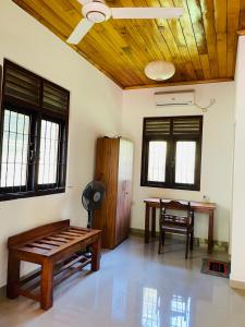 a room with a table and a bench in it at Rathna Villas in Bentota