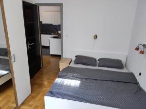 a small bedroom with a bed and a kitchen at Fildor in Zagreb