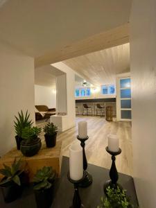 a living room with plants and candles on a table at La Casa du Lac in Le Bourget-du-Lac