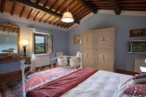 a bedroom with a bed and a table and chairs at Agriturismo Castello di Montauto in San Gimignano