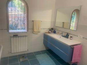 a bathroom with a sink and a mirror at VILLA TARA in Quercianella +31 photos