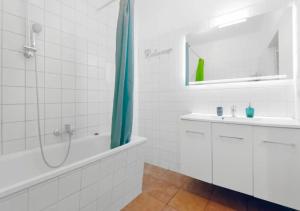 a white bathroom with a sink and a shower at Modern 2 Bedroom Apartment in Midtown West in New York