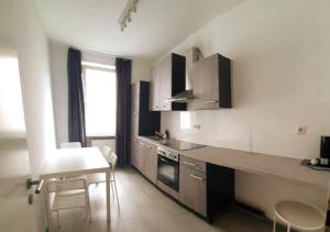 a kitchen with a counter and a table and chairs at Modern 2 Bedroom Apartment in Midtown West in New York