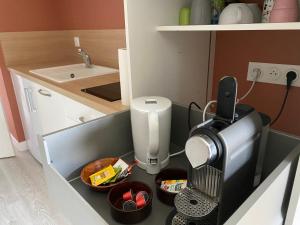 - un comptoir de cuisine avec une cafetière et de la nourriture dans l'établissement Appartement BIENVENUE au calme quartier Venoix, à Caen