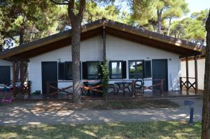 a house with a picnic table in front of it at Settebello Village in Lido Di Fondi