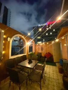 a room with a table and chairs and a building at Cafe ice resident in Yan Nawa