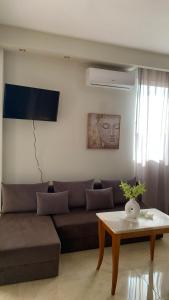 a living room with a couch and a coffee table at City view apartments 4 in Serres