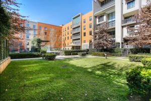 a grassy yard in an apartment complex with buildings at Melrose Arch Luxury Apartment - WITH GENERATOR in Johannesburg