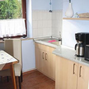 a kitchen with a sink and a counter top at Fewo Leopold - Ferienwohnung 1 in Cuxhaven +18 photos