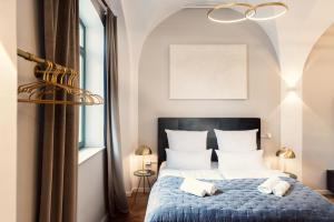 Schlafzimmer mit einem blauen Bett und weißen Kissen in der Unterkunft NEW LUXUS Suite I TWO Kingbeds I Center I Netflix in Augsburg