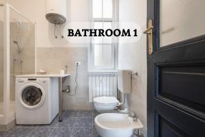 a bathroom with a washing machine and a toilet at Trieste Centre - Reserved Parking & Wi-Fi in Trieste