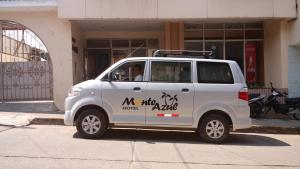 a white van parked in front of a building at Hotel Monte Azul in Tarapoto