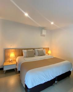 a bedroom with a large bed with two lights on it at Room in Guest room - Elegant And Sophisticated Suite in Rionegro
