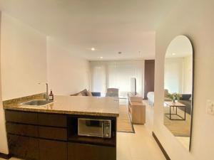 a kitchen with a sink and a living room at Room in Guest room - Elegant And Sophisticated Suite in Rionegro