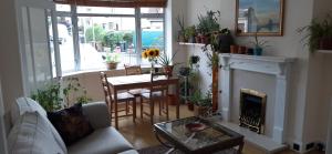 a living room with a table and a fireplace at Dryden Gardens in Edinburgh