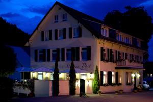 a white building with a sign that reads guest post at Gasthaus Sternen Post in Oberried