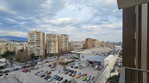 a city with cars parked in a parking lot at Anika Luxury apartment at Diamond center in Skopje