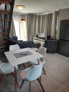a living room with a white table and chairs at Kyalami Boulevard Estate, Kyalami Hills ext 10 Robin Road Midrand in Midrand