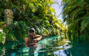 a woman in a pool of water in a jungle at Royal River, Luxury Hotel - Adults Only in Adeje
